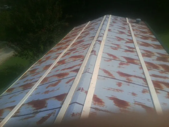 Rusted metal roof panels with new wood purlins before replacement — Storm Damage Roof Repair in Azalea by Roofing Brothers